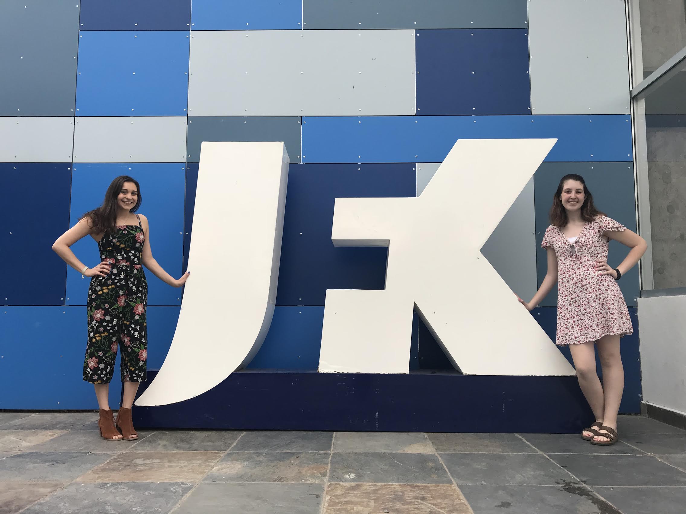 Allison and Maddie standing by the JFK school sign