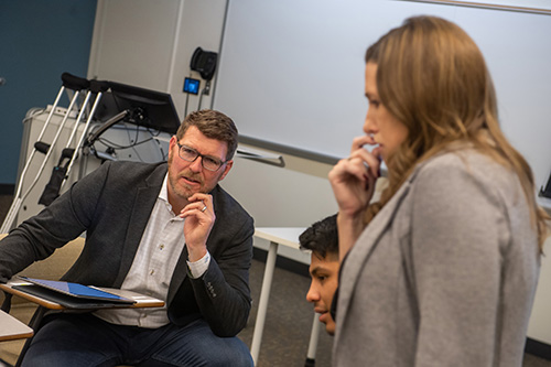 Talluto works with Illinois Wesleyan Instructor and Director of DTE Tara Gerstner ’01 and students in an upper-level DTE course he co-teaches. 