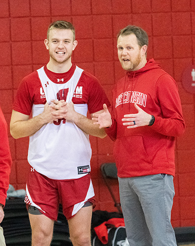 McGehee talks with University of Wisconsin men’s basketball player Brad Davison during a recent practice. 