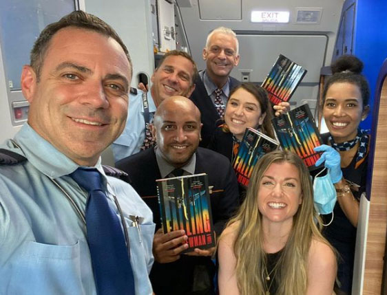 Newman’s readers include many former co-workers, including this flight crew she snapped a photo with in July 2021.