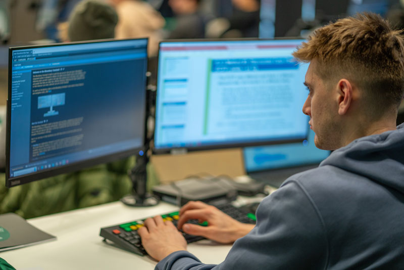 A student uses one of the 12 Bloomberg Terminals available in the Greg Yess '82 Bloomberg Finance Lab in State Farm Hall.