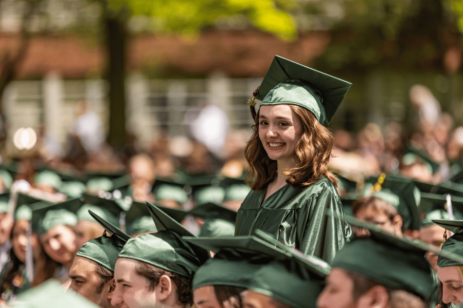 A student stands in the crowd during IWU graduation
