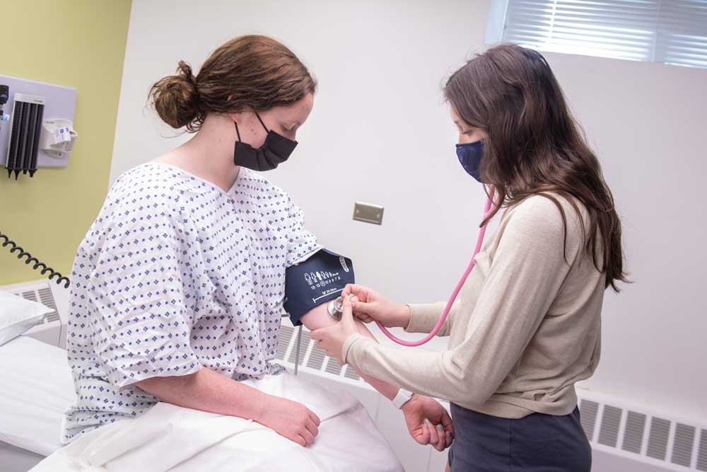 Nursing student practicing taking blood pressure