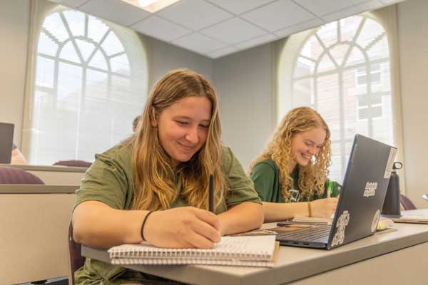 Students take notes during a Human Nutrition course.