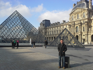 Matt LaLonde standing in front of the Louvre Museum