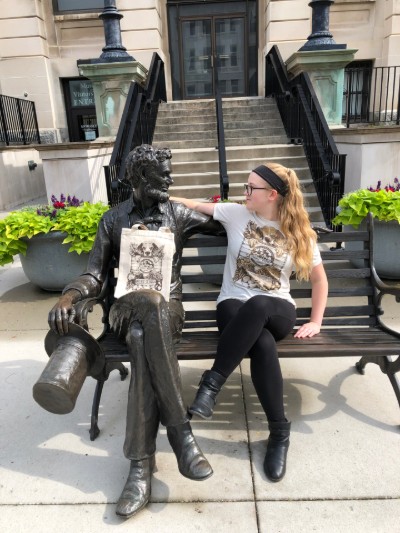 Hannah poses downtown with the lincoln statue