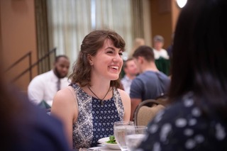 Katherine Henebry laughing at a formal dinner