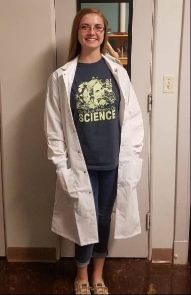 Leah Bieniak posing for a photo in a white lab coat.