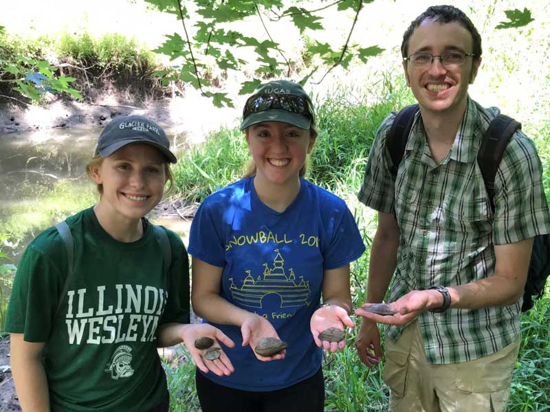 Students conduct summer research on mussel microhabitat preferences with Dr. Aaron Wilson.
