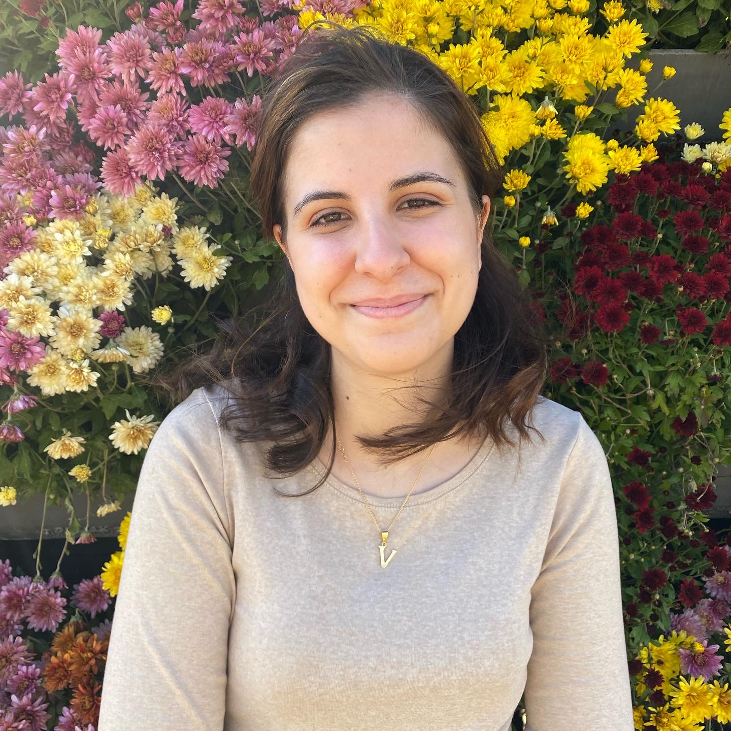 Victoria Ballesteros-Gonzalez with flowers in background