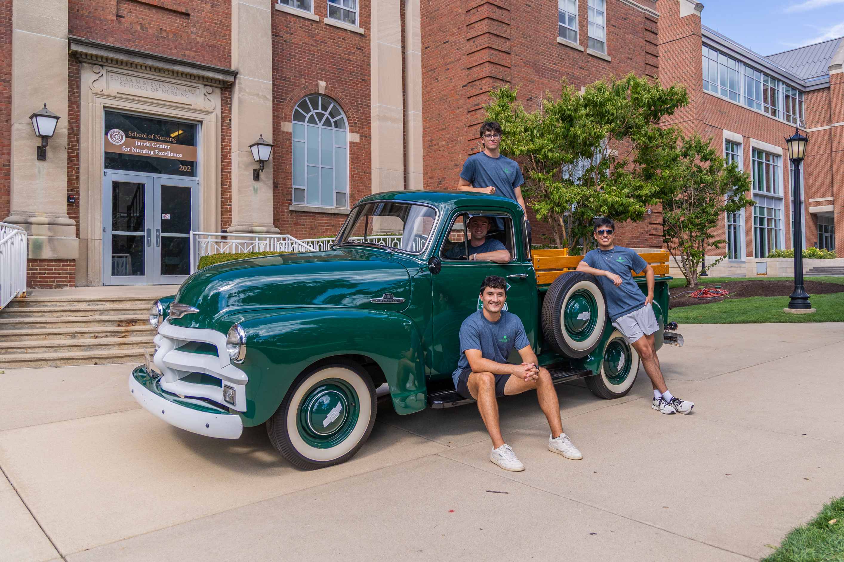 IFC Men in front of green truck