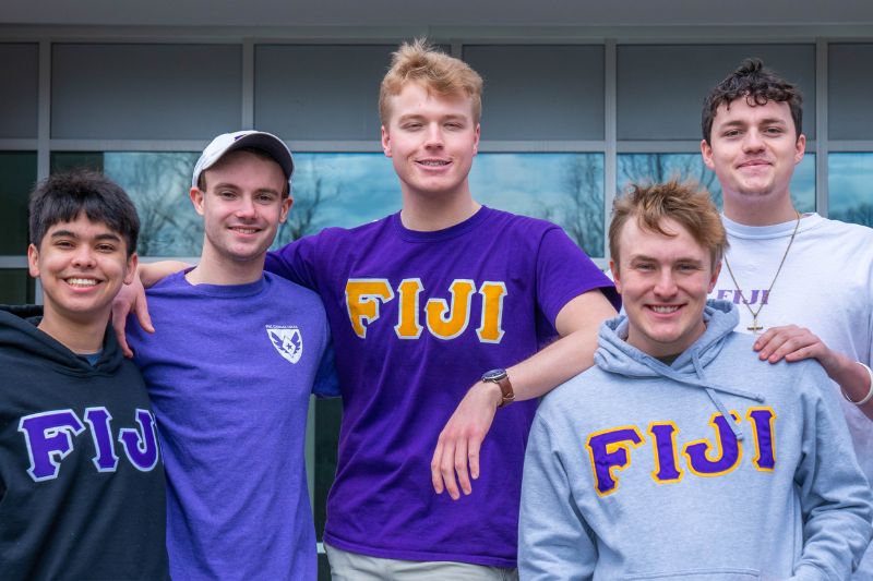 Five members of Phi Gamma Delta wearing FIJI letters