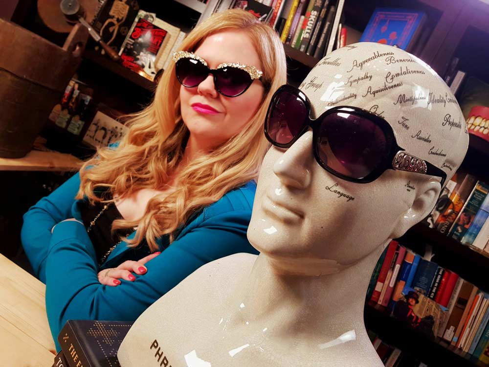 Fitzharris poses with a phrenology head in the most recent episode of her YouTube series Under The Knife.