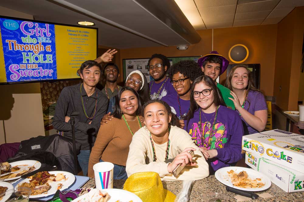 Members of Illinois Wesleyan’s inaugural class of Posse Scholars pose for a picture at a Mardi Gras celebration in the Memorial Center’s Dugout, on Feb. 9, 2018. Members of the group are from the New Orleans area and played key roles in the organization of the event. 