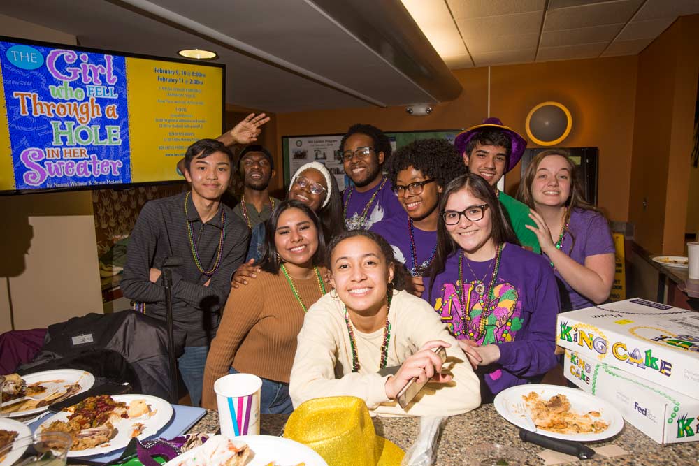 Members of Illinois Wesleyan’s inaugural class of Posse Scholars pose for a picture at a Mardi Gras celebration in the Memorial Center’s Dugout, on Feb. 9, 2018. Members of the group are from the New Orleans area and played key roles in the organization of the event.
