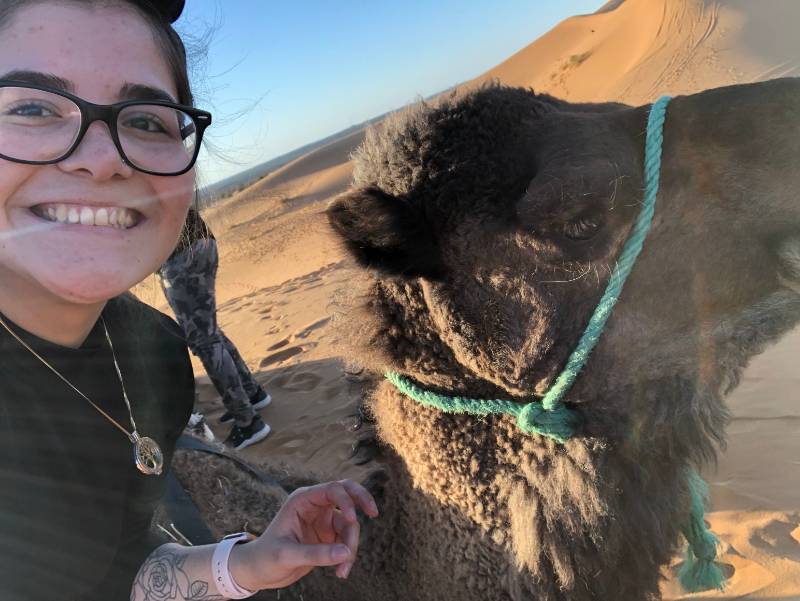 Shakira Cruz Gonzalez ’21 rides a camel in the Sahara desert in February 2020. Cruz Gonzalez was one of dozens of Illinois Wesleyan students abroad who faced challenges while attempting to return home at the outset of the COVID-19 pandemic.