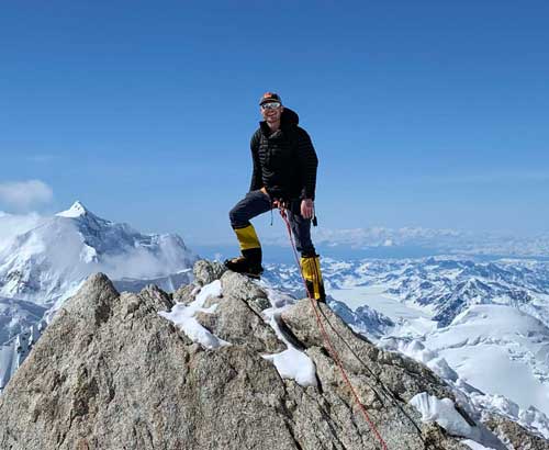 Andrew Baldock ’99 poses for a photo at “The Edge of the World” on Denali’s West Buttress route.