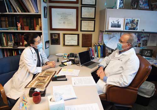 Eckerle (left) talks with her longtime mentor Dr. Dana Johnson (right) in his office at M Health Fairview University of Minnesota Masonic Children’s Hospital.