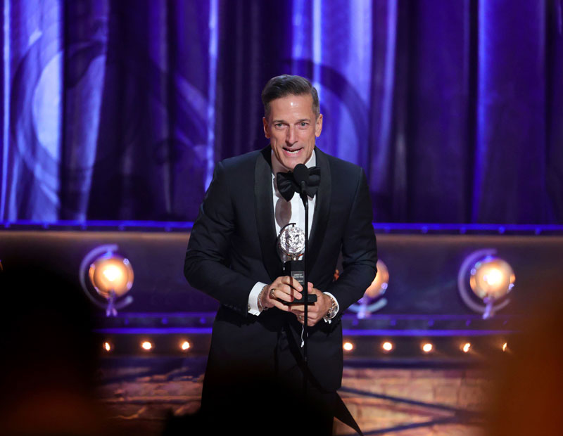 Bill Damaschke ’85 accepts the Tony Award for Best Musical at the 74th annual Tony Awards on Sept. 26, 2021. (Opposite page) Moulin Rouge! The Musical