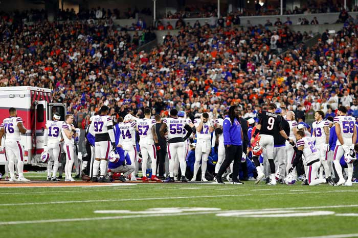 Immediately after Hamlin collapsed, the on-site UC Medical first responders rush to restart his heart while his teammates anxiously watch. Photo credit: Getty Images