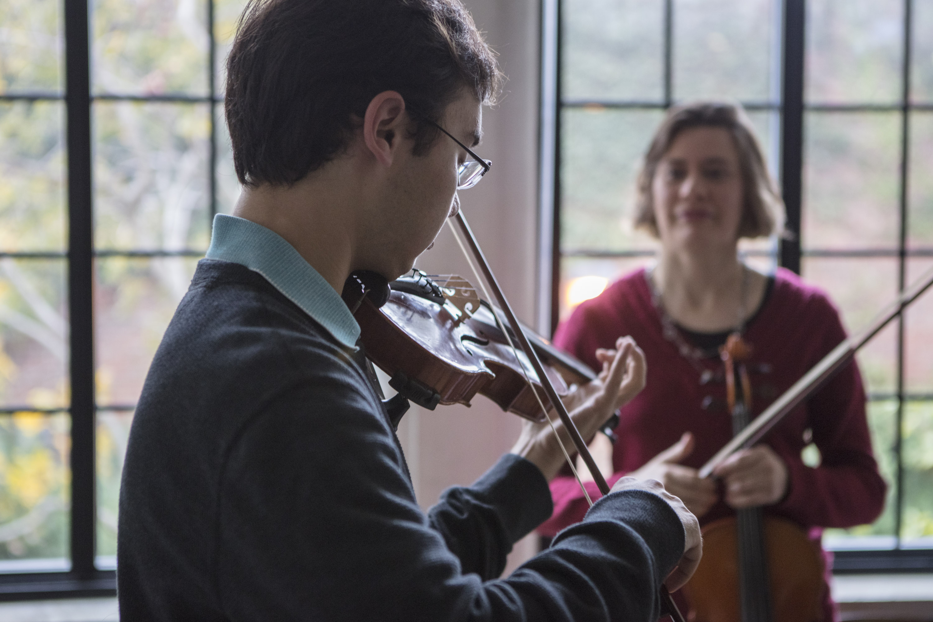 Music student - violin Music student playing violin with teacher looking on