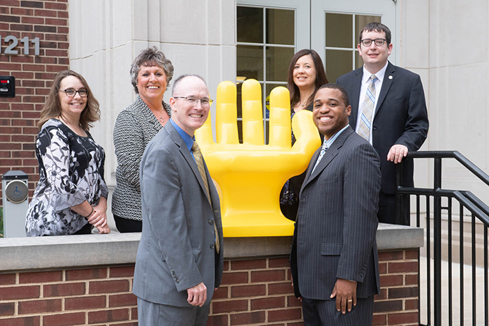 Career Center staff with Handshake hand