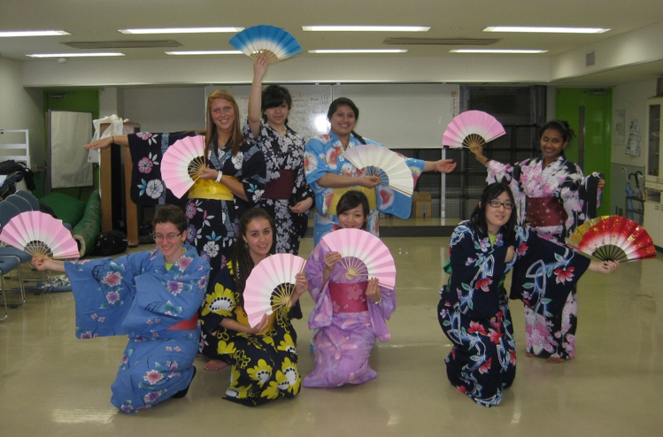 Visiting students learn a traditional dance. 