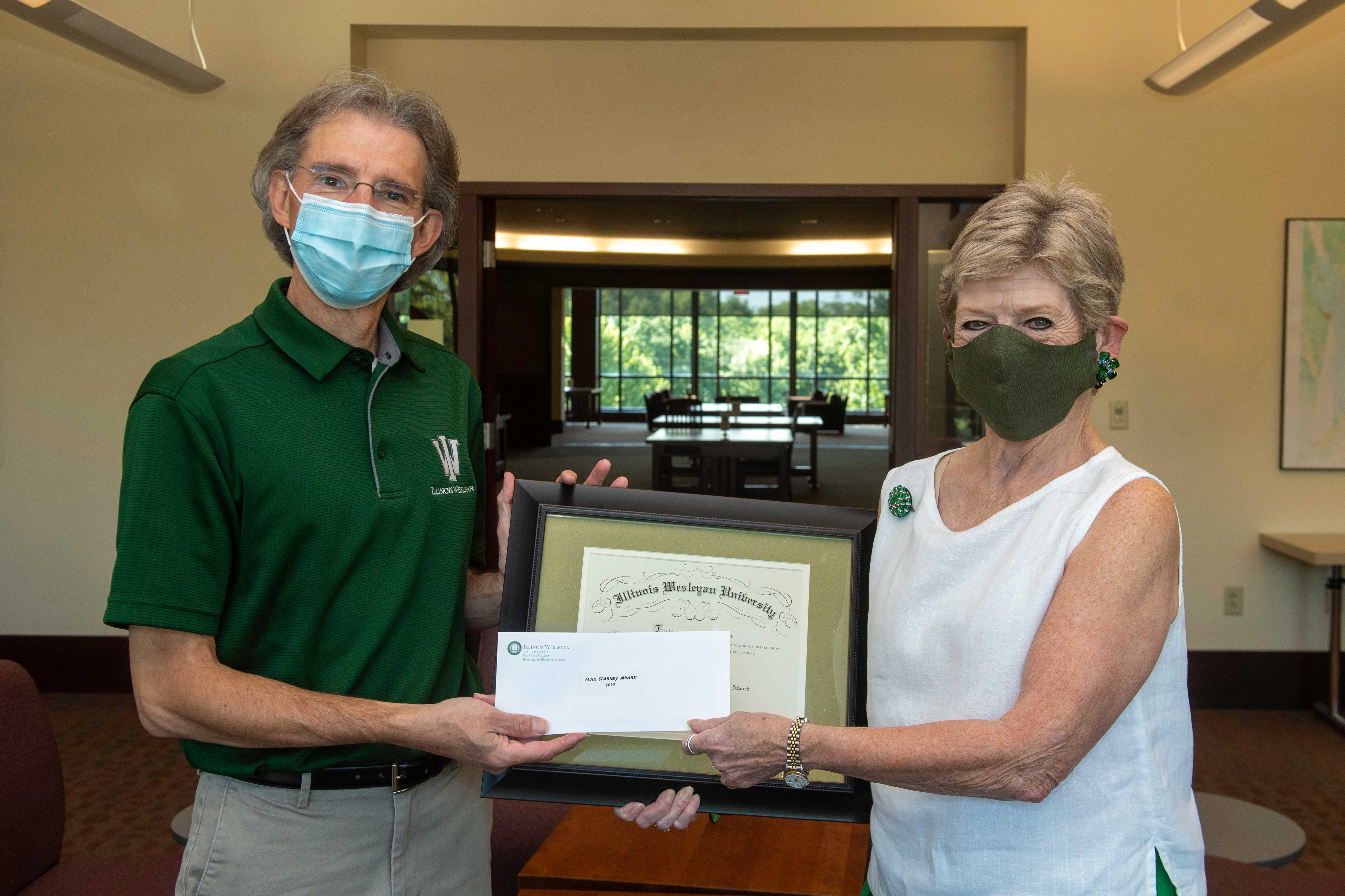 Trey accepts Starkey award from President Nugent