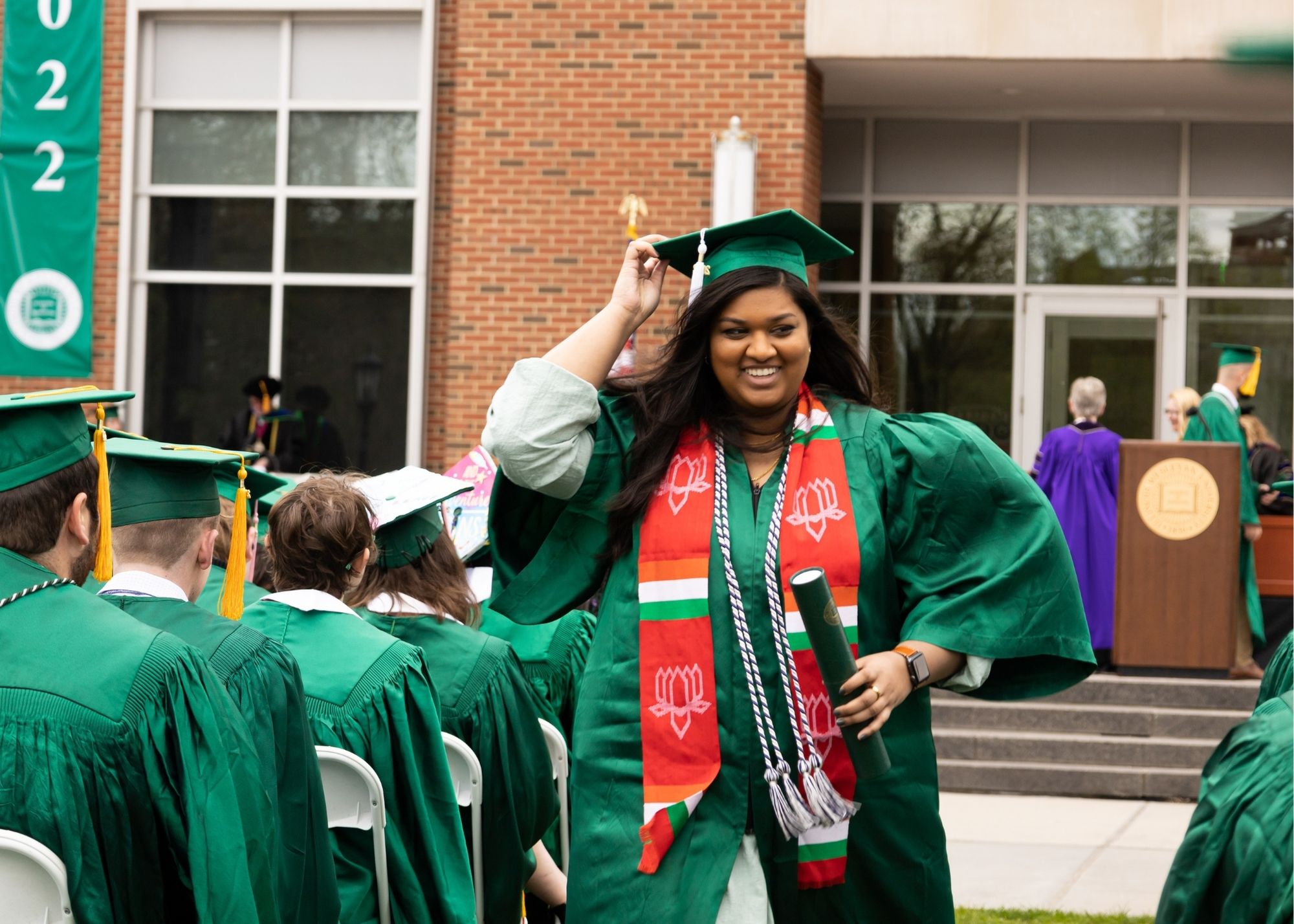 student walking away with diploma