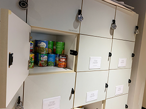 door open on food pantry showing canned goods