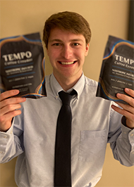 Jeremy Glickman holding bags of Tempo, a coffee creamer he designed.