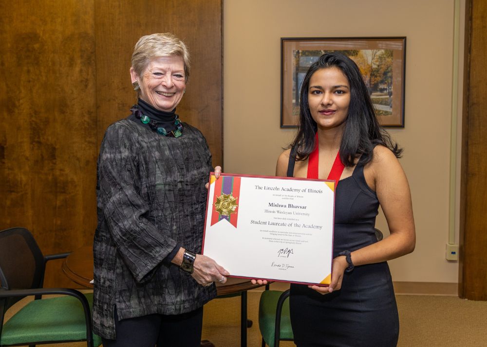 President Nugent stands with Mishwa Bhavsar '23 who is holding her Lincoln Laureate award certificate 