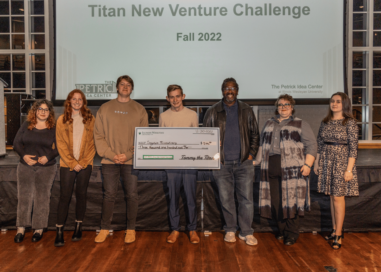 Four students (to the left) received grants after presenting original ideas at the Titan New Venture Challenge on Nov. 30 at Hansen Student Center.