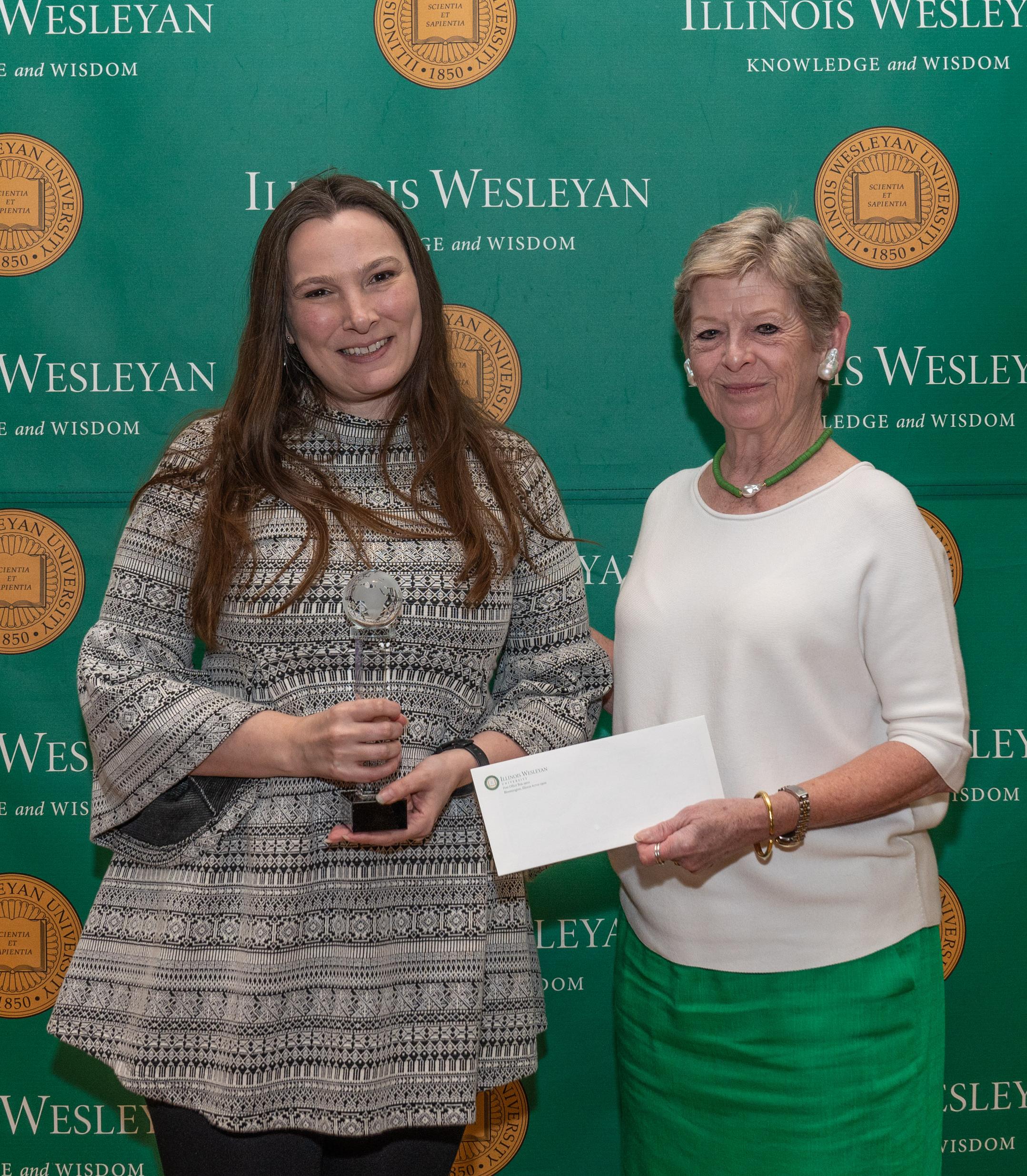 Courtney Irby accepting award from IWU President Georgia Nugent