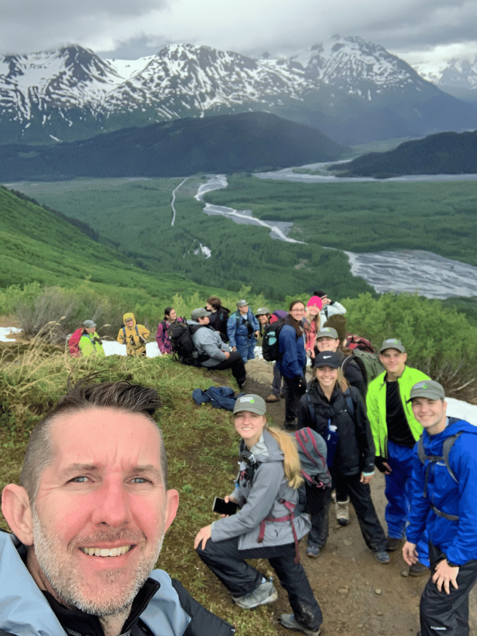 Scott Collins hiking with students near mountain range