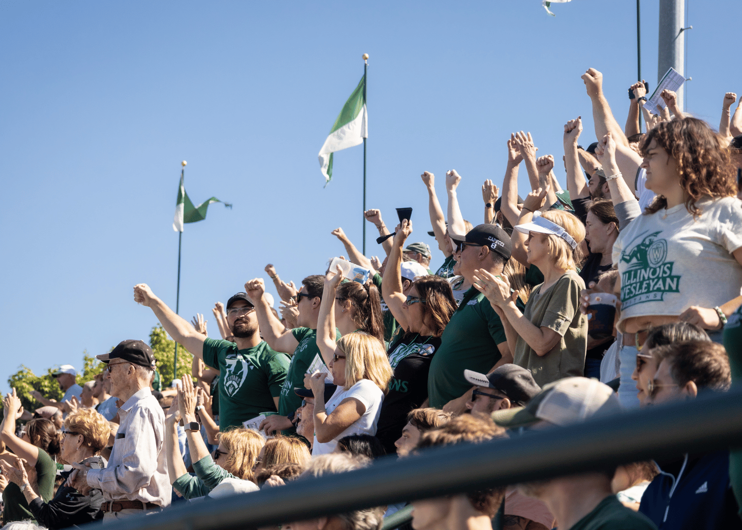 Illinois Wesleyan University fans cheer from the stands of Tucci Stadium during the 2022 homecoming football game