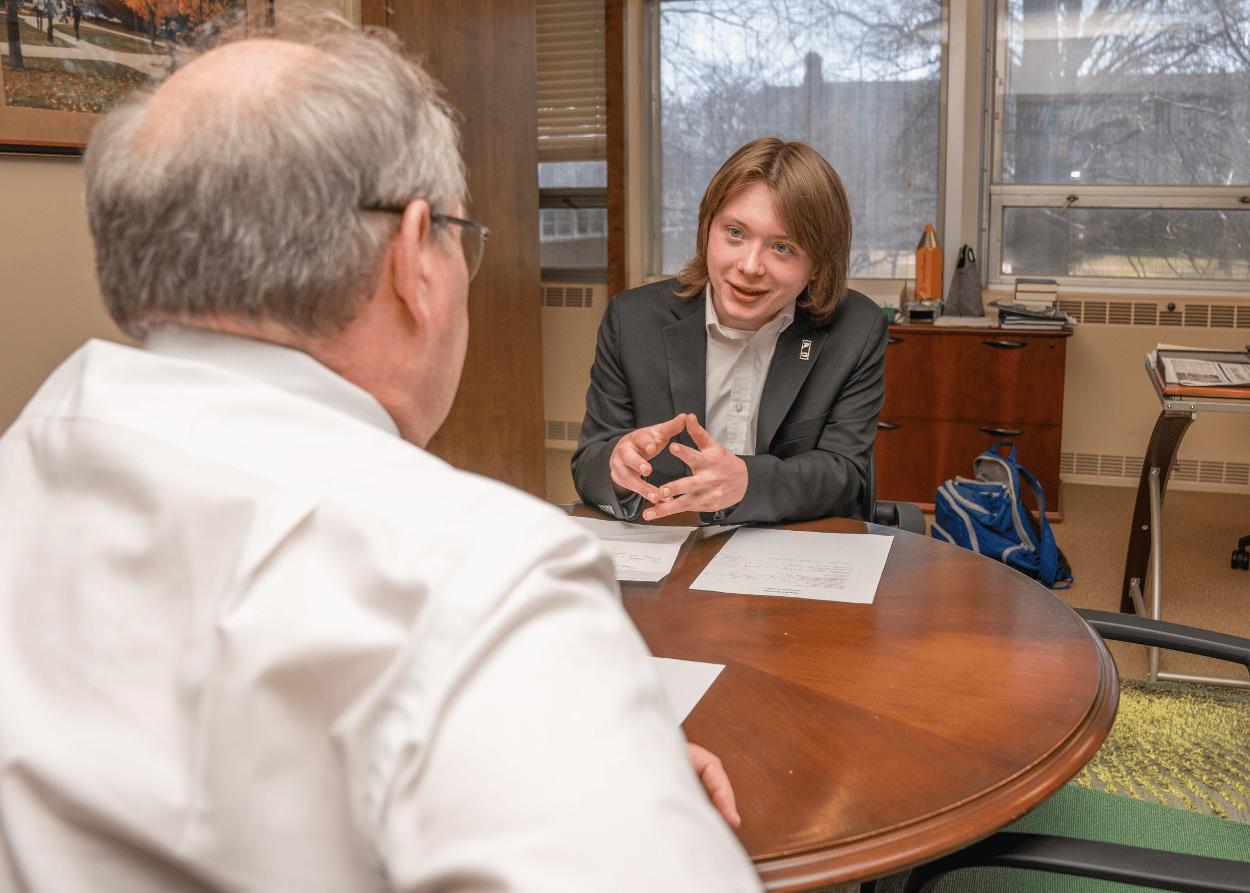 Liam Killian meets with Carl Teichman in the Presidents Office at IWU