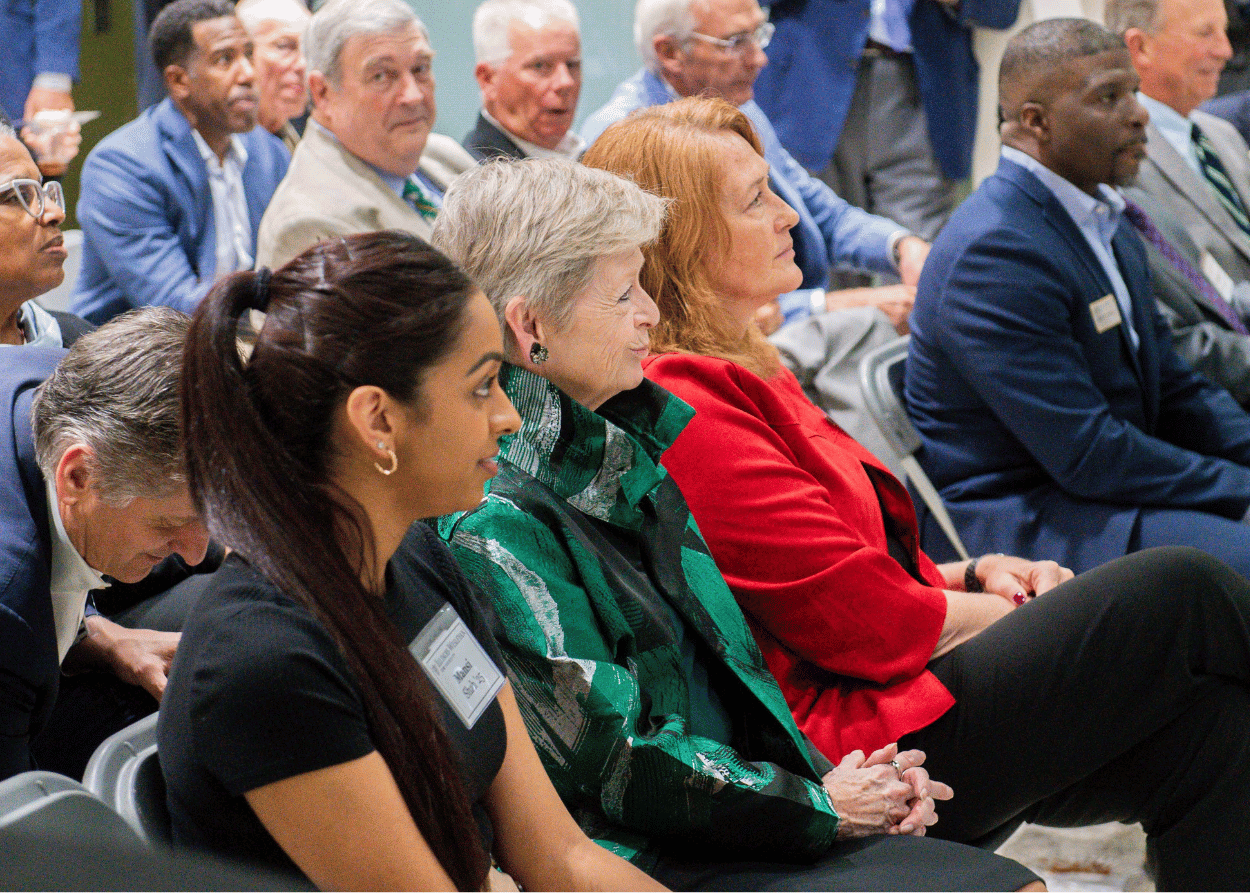 Seated crowd with IWU student, President Georgia Nugent and State Farm executive in the foreground