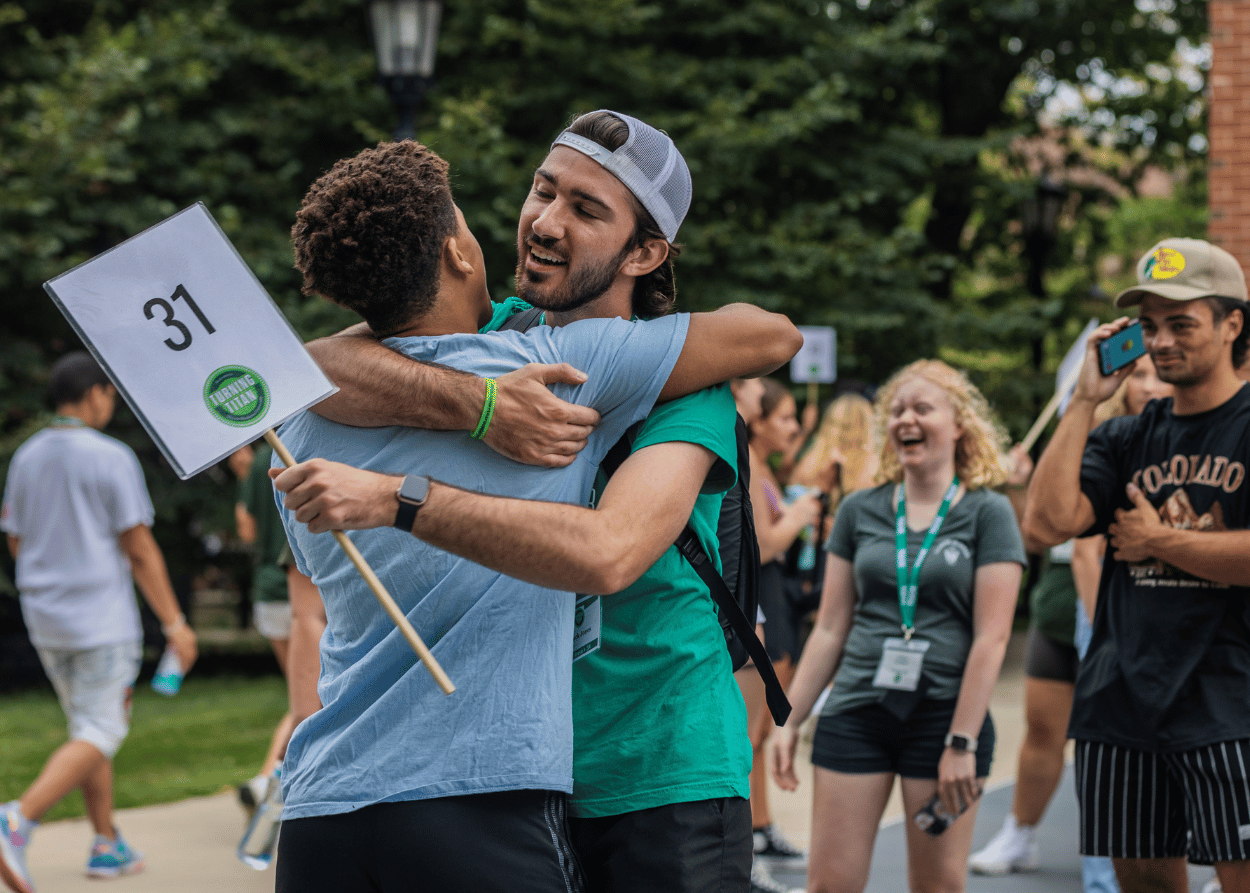 Two Illinois Wesleyan University students embrace after an activity on campus during Turning Titan
