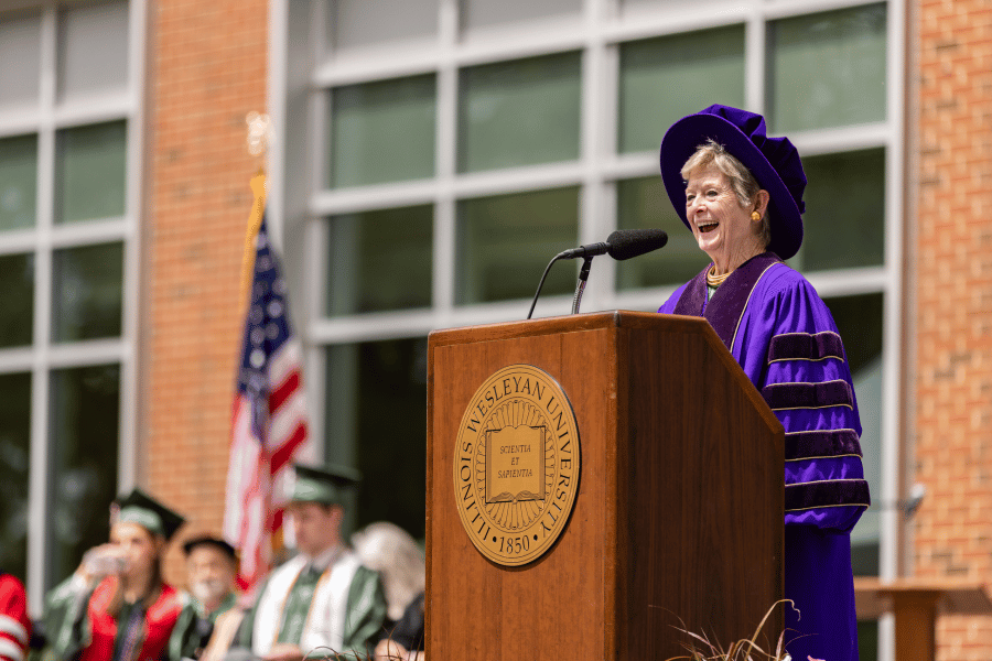President Georgia Nugent speaks at podium during IWU commencement
