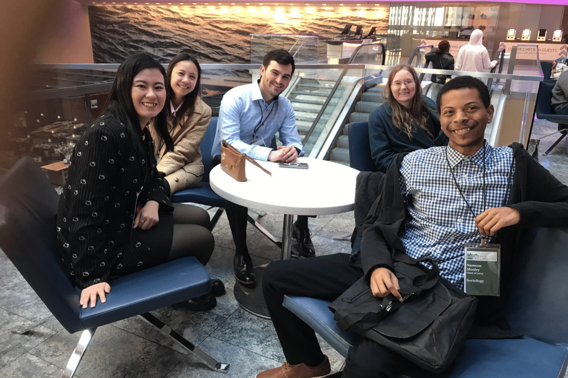 Students sitting around a lobby table at a business in Chicago