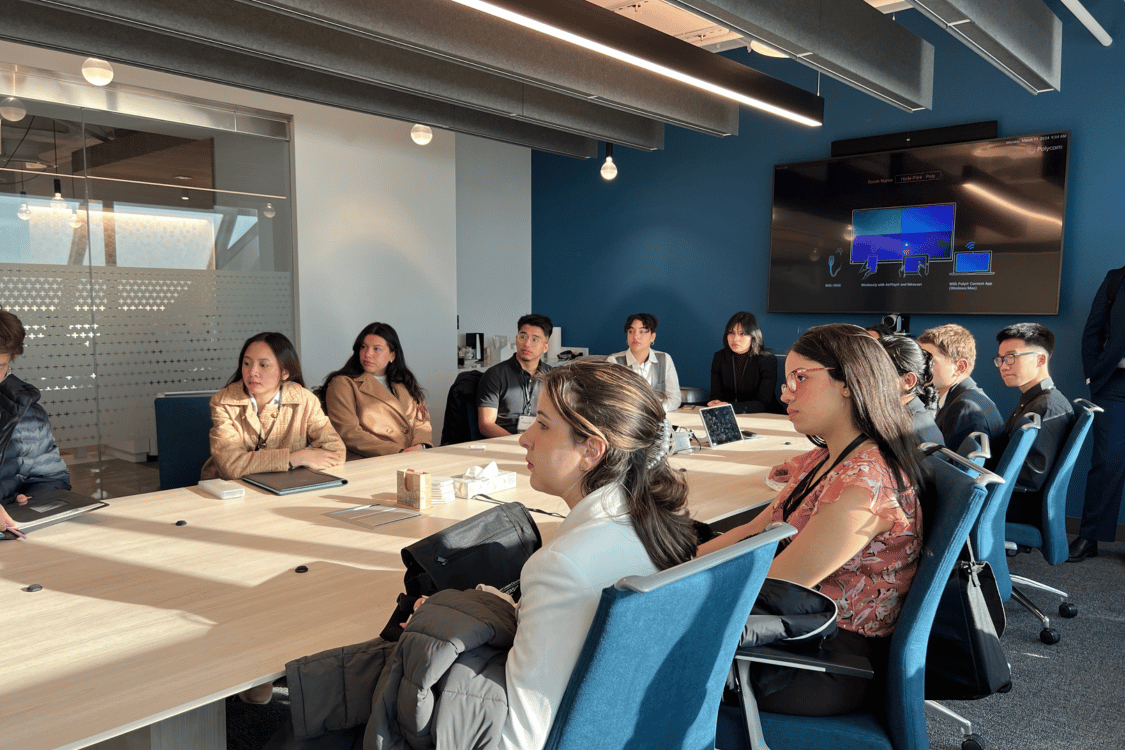 Students sitting at a table in a board room