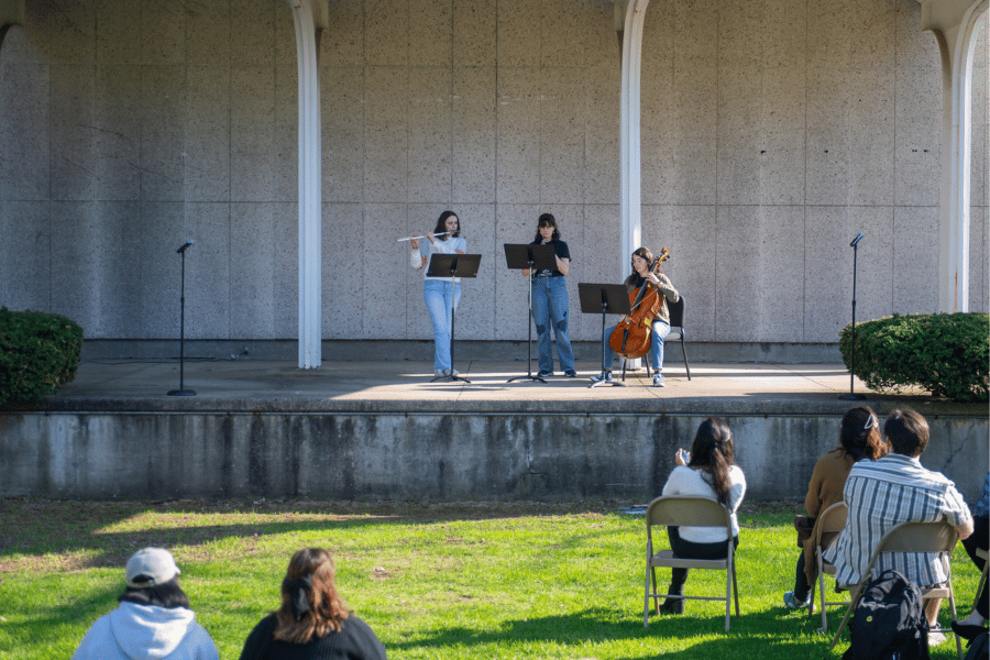 Students play instruments on the stage of McPherson Beach at IWU