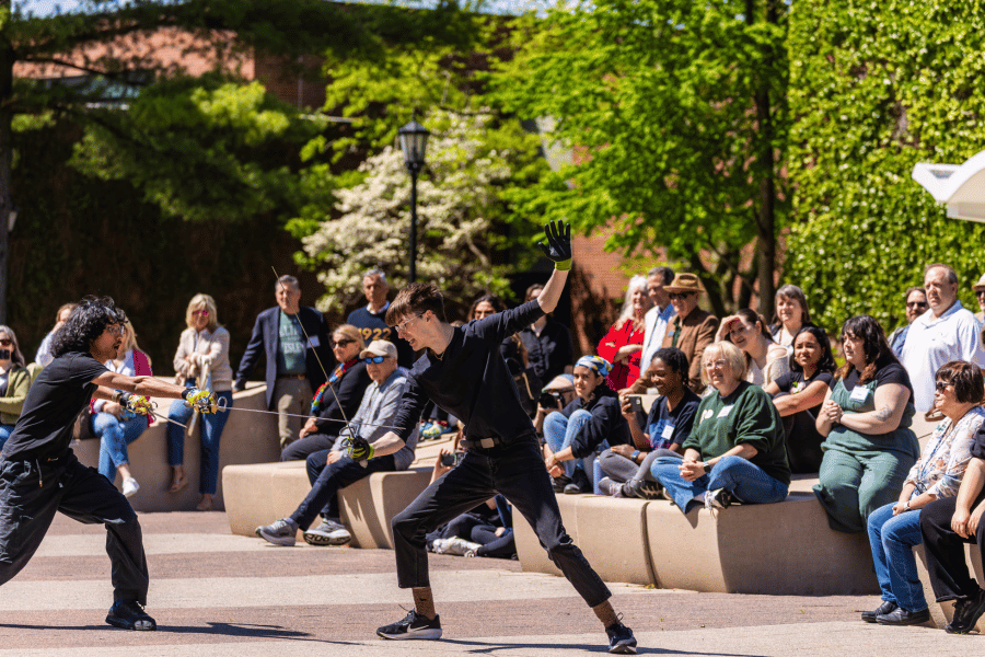 IWU students fencing on Ames Plaza in front of audience at Festival for the Arts