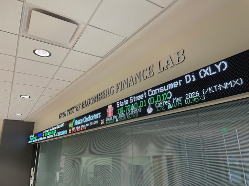 Students working in a modern finance trading lab environment