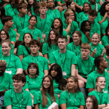 iwu students in green shirts at assembly