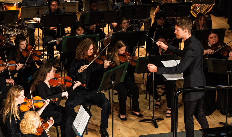 Director Logan Campbell at a former wind symphony event at IWU