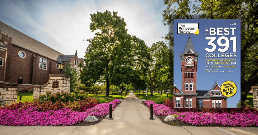 flowers and trees surrounding a sidewalk going through IWU's campus with a copy of The Princeton Review
