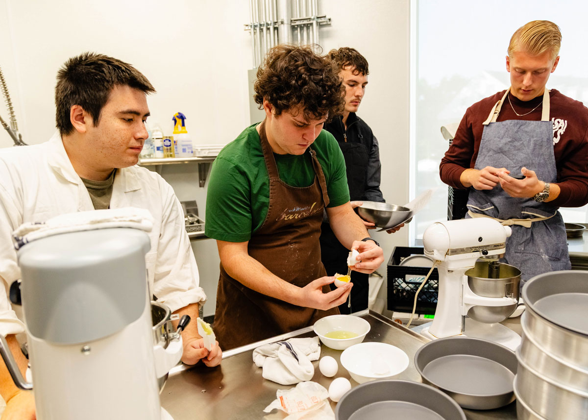 Cracking eggs and preparing ingredients.