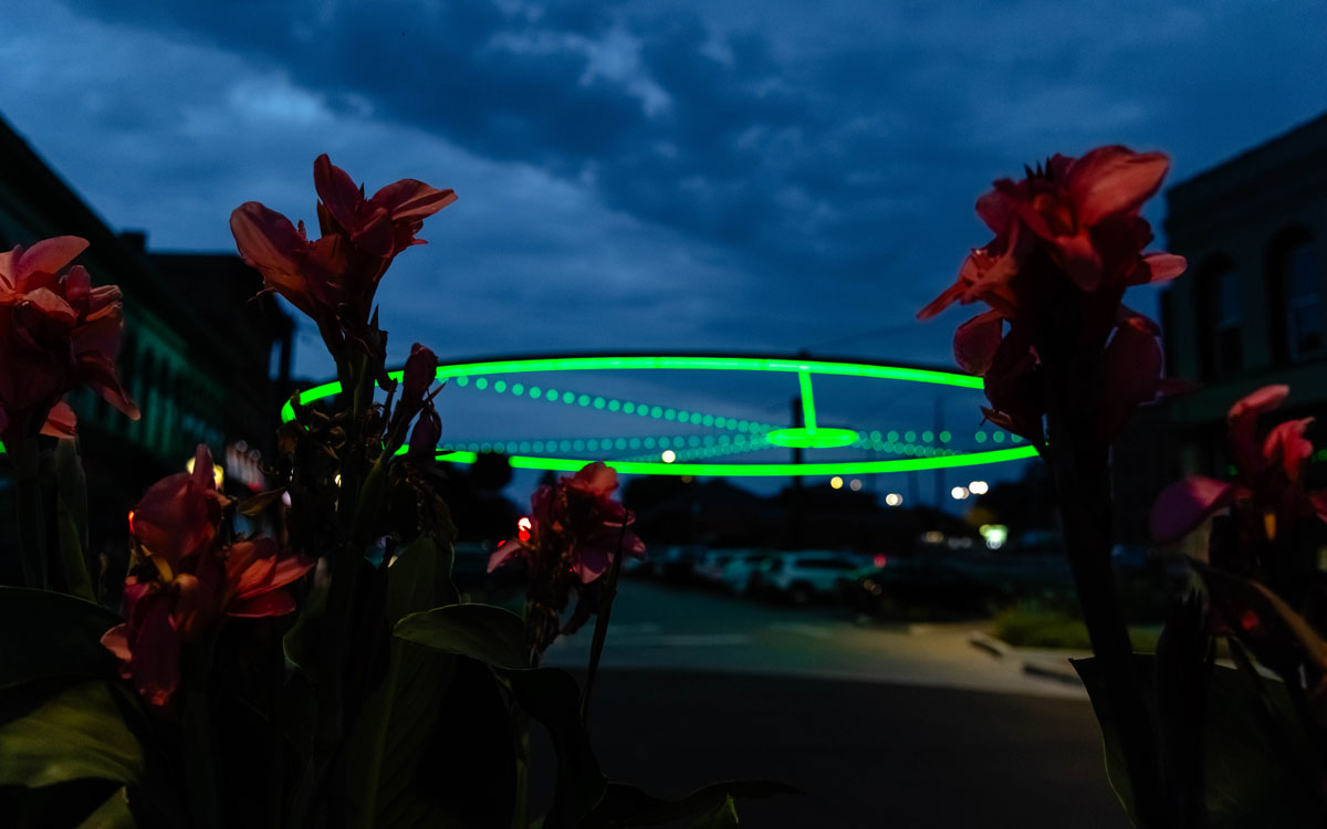 Ring in Downtown Bloomington lit green for IWU Homecoming